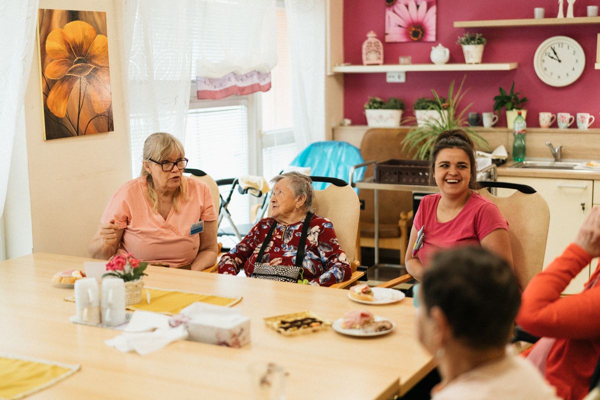 Residentes y cuidadores en el comedor de una residencia de mayores